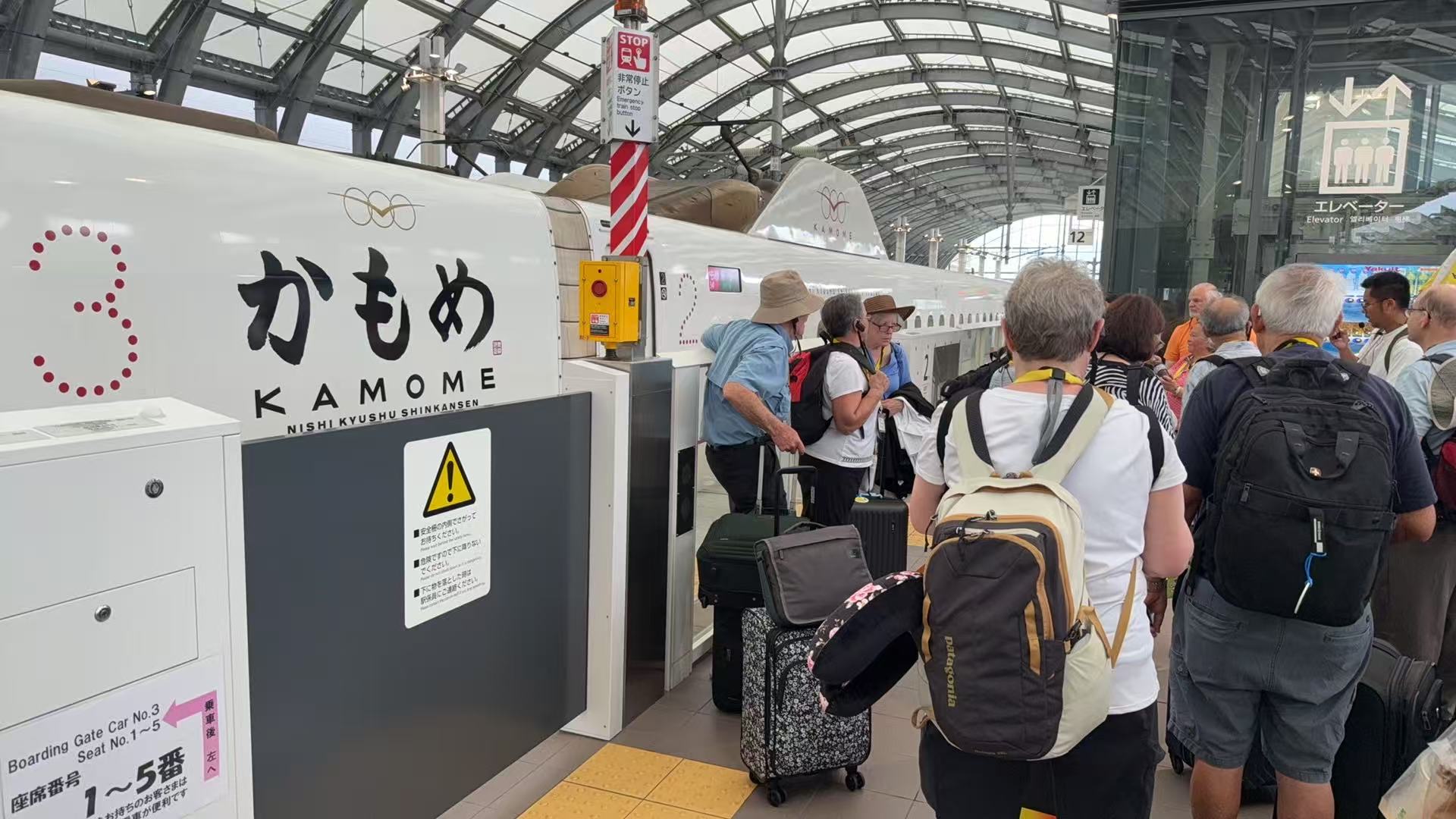 Pilgrims preparing to board the Kamome Nishi Kyushu Shinkansen with their luggage